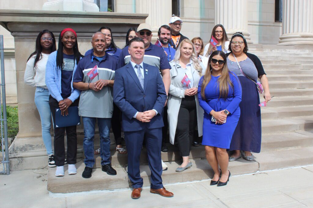 Helix Human Services employees pose for a photo at the Child Abuse Prevention flag raising ceremony.