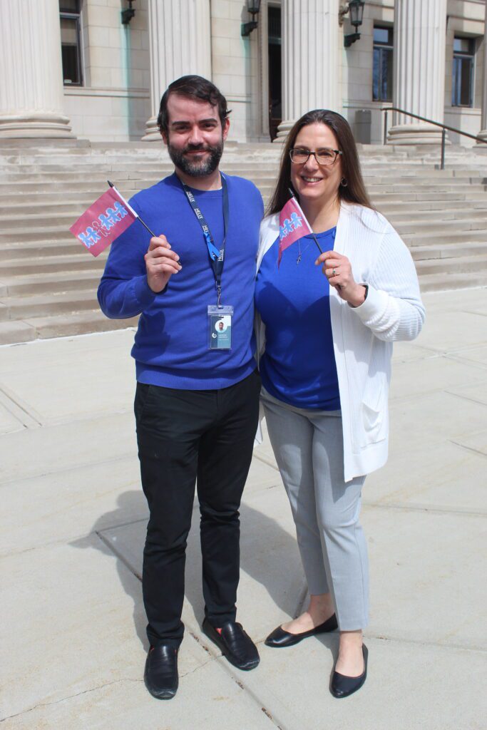 Helix Human Services employees Anthony and Kristin pose for a photo at the Child Abuse Prevention flag raising ceremony.