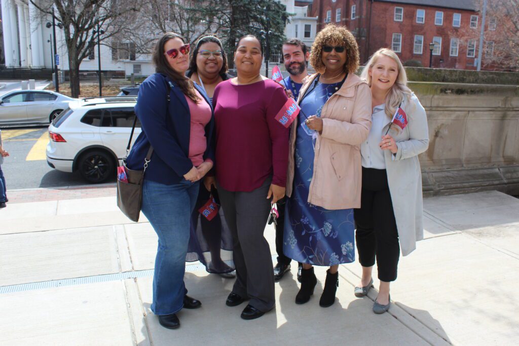 Helix Human Services employees pose for a photo at the Child Abuse Prevention flag raising ceremony.