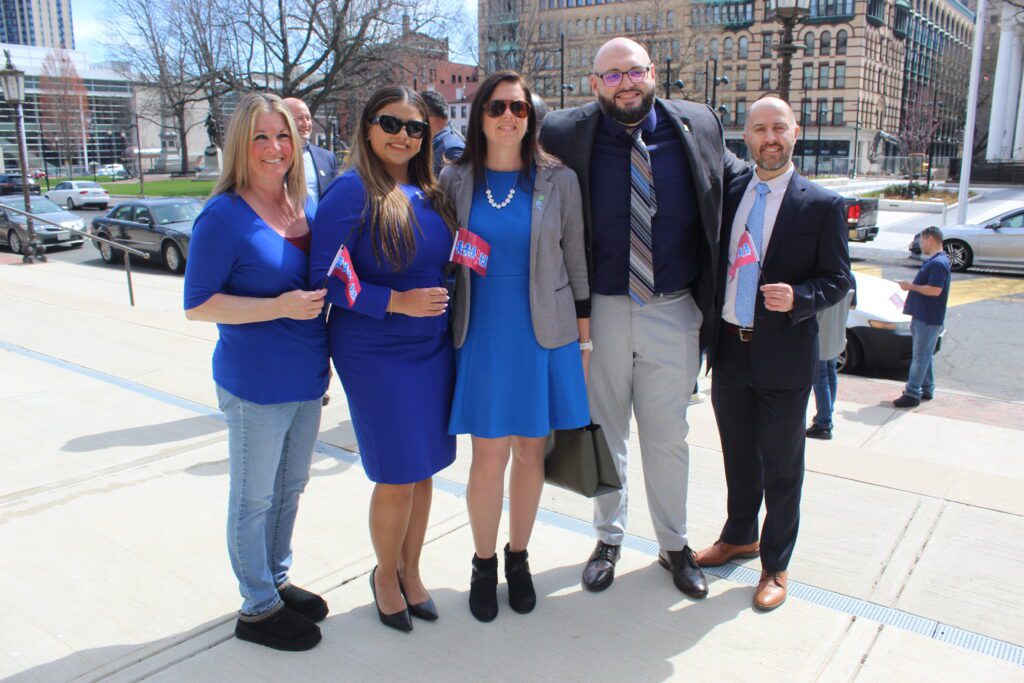 Lisa Zarcone, child abuse prevention advocate and Yamilca Nogue chief relations officer at Helix Human Services pose with TD Bank staff and Jay Latorre III